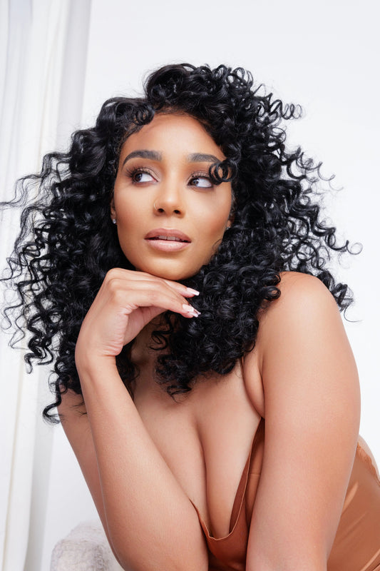Image alt text suggestion: “Model rocking loose curly hair extensions in Island Curl Texture—humidity proof curls, perfect for beach-ready summer hair.” Looking for hot curl summer perfection? Try Island Curl. Finish with a high texture glam selfie.