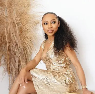 Woman wearing Island Curl loose curly hair extensions ponytail for humidity proof curls and summer bounce.