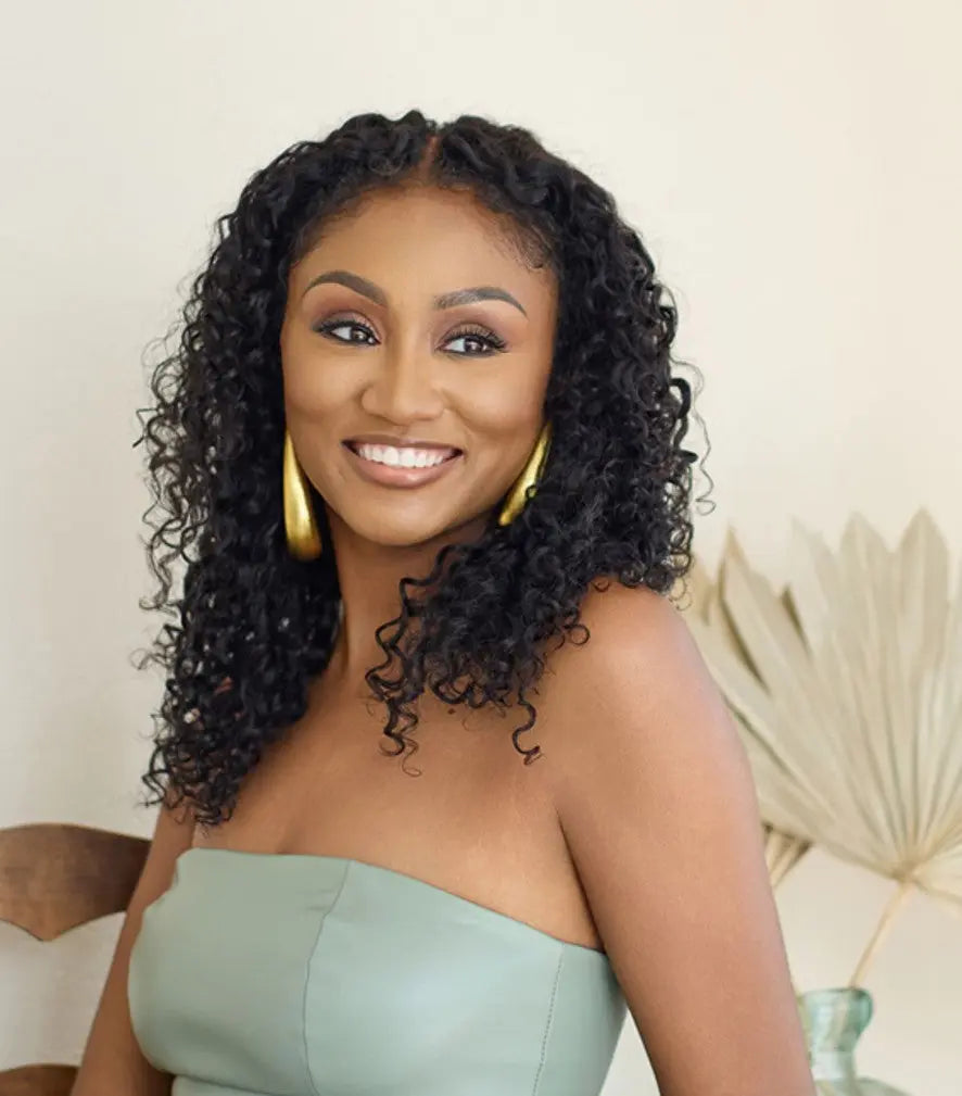 Woman celebrating her natural curls after ditching flat iron fatigue with Island Curl loose curly hair extensions for volume manageability & frizz-control in humidity.