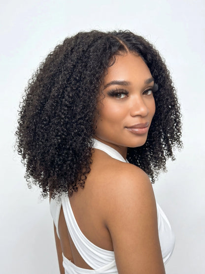 Layla Curl Kinky Curly TruPart is a luxury V part and U part wig crafted from raw hair for a full, natural kinky curly blend. Better than a traditional half wig, it delivers dense volume, seamless integration, and easy scalp access for a polished, natural finish.
